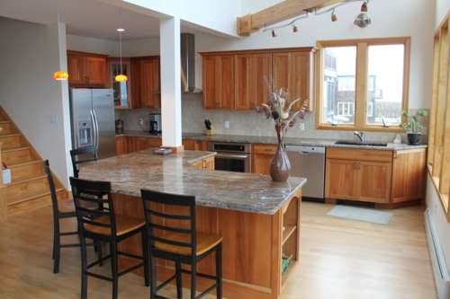 which countertop with light maple flooring and cherry cabinets ...